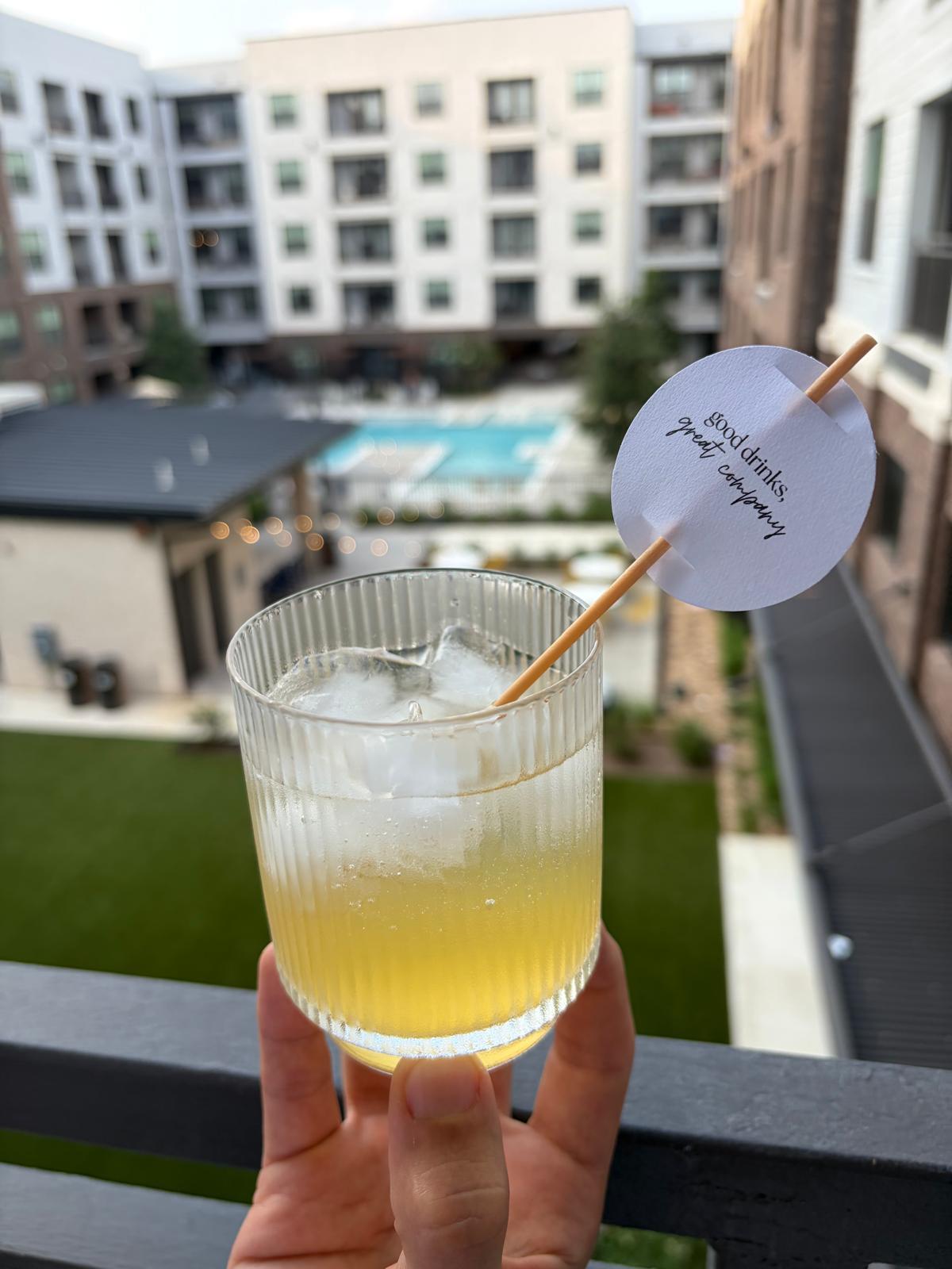 Hand holding ribbed glass with good drinks great company topper outdoors