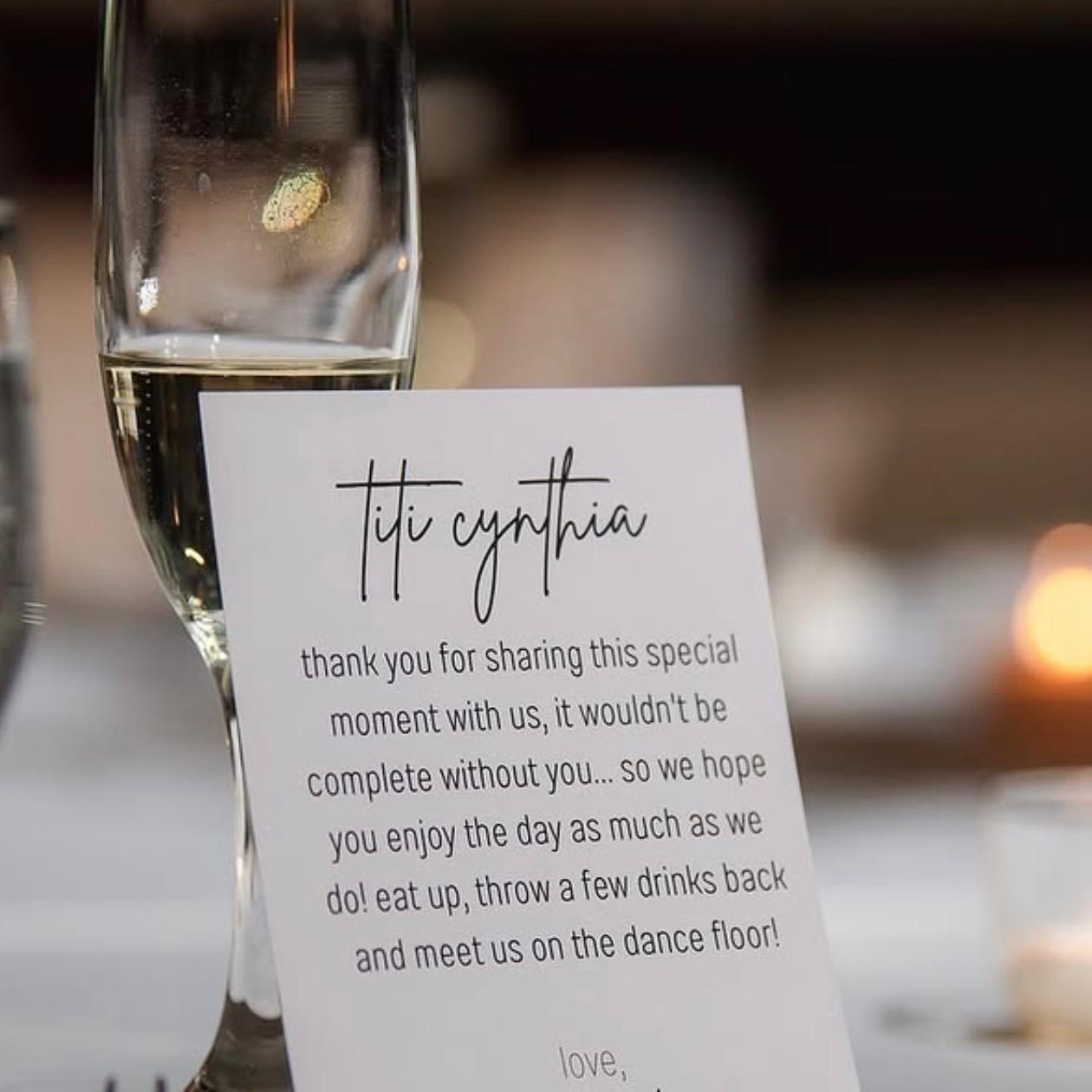Personal thank-you note card next to a champagne flute