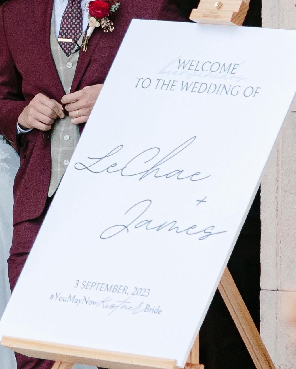 Tall welcome sign at a wedding entrance